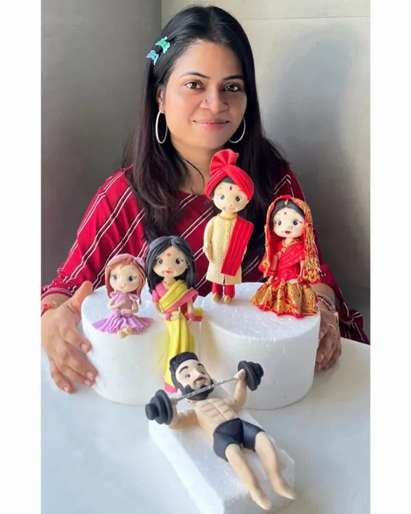 A showcase of my handcrafted fondant figurines. Each one, from the fitness enthusiast to the traditional Indian couple, is sculpted with love and passion to bring your sweet moments to life.