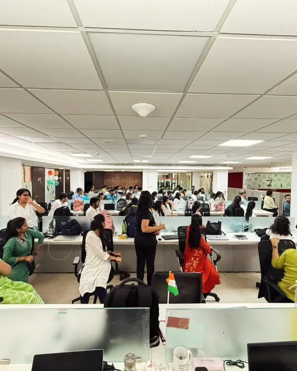 A wide shot of a corporate yoga wellness program I conducted. Even in a busy office, we can create a space for employees to breathe, stretch, and reset.