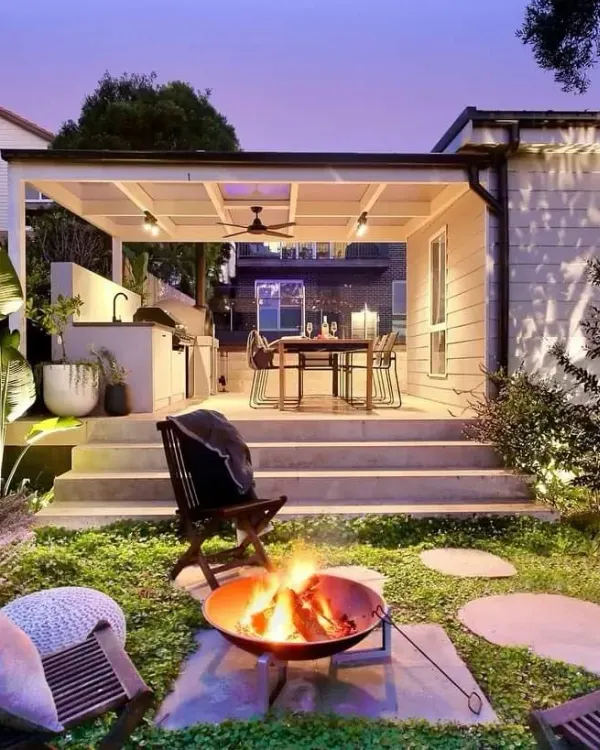 I create cozy evening retreats with features like this fire pit and covered dining area. The right lighting makes the space usable and beautiful after sunset, perfect for relaxing or entertaining.