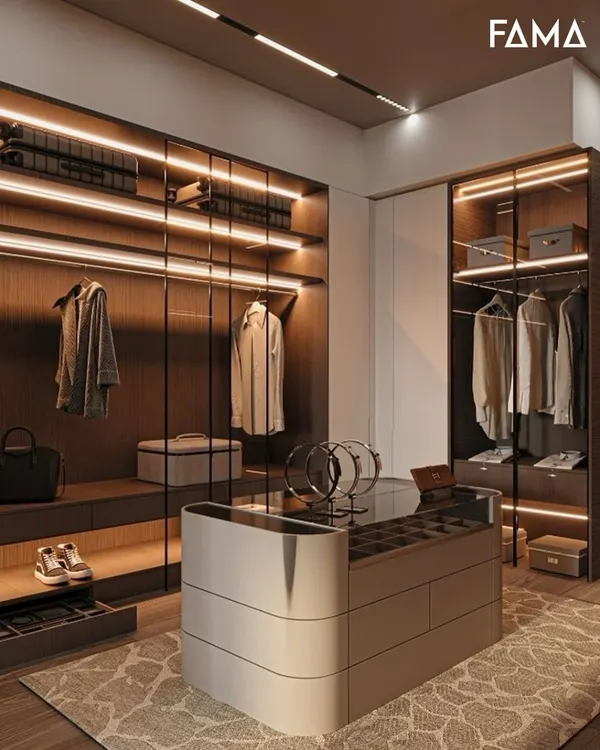 This is what we mean by a mood starter. This walk-in closet combines dark wood tones with integrated LED lighting to create a space that’s both dramatic and perfectly organized. Notice the central island with a glass top for accessories and the dedicated shelving for shoes and bags, making it a truly custom dressing room.