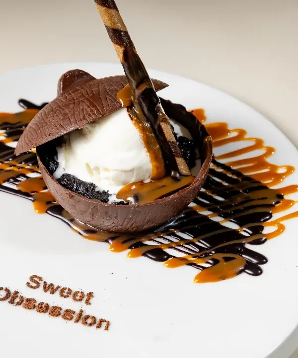 Surrender to our signature "Death by Chocolate" dessert. A rich chocolate dome melts to reveal creamy vanilla ice cream, all drizzled with chocolate and caramel sauce. It's pure indulgence.