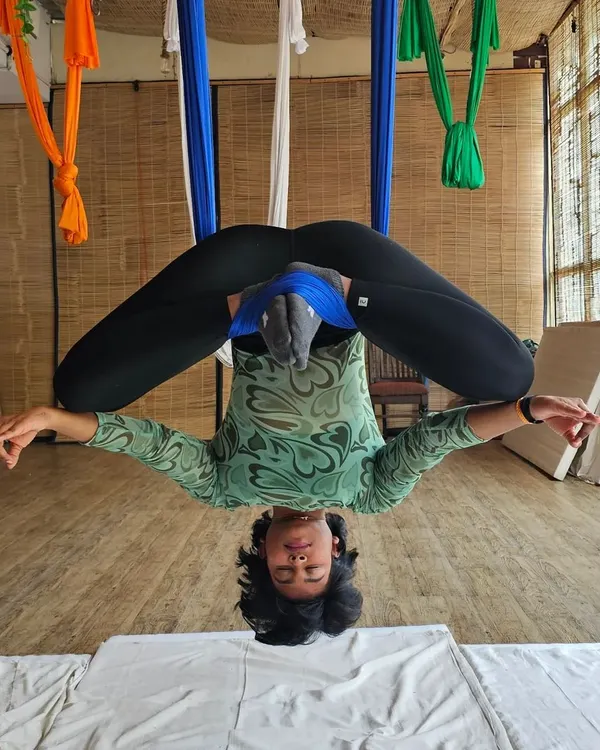 Finding balance and peace in an inverted butterfly pose during my aerial yoga certification. This posture is amazing for opening the hips and decompressing the lower back, all while being fully supported by the hammock.