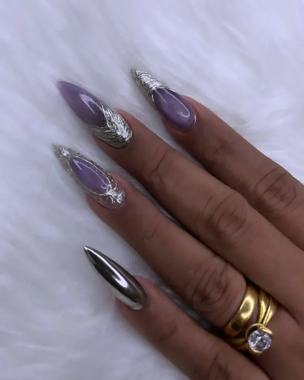 This is where nail art becomes high fashion. I created this dramatic look using sharp stiletto extensions, a soft lavender base, and striking 3D silver chrome accents for a futuristic and elegant finish.