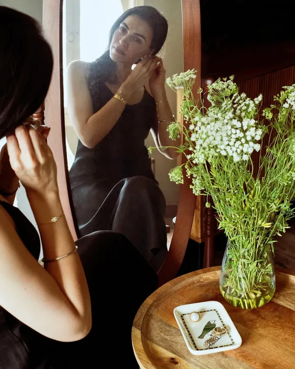 A personal moment of getting ready, captured for Patrika Gift Shop. This shot shows their jewelry being worn in a natural, intimate setting, telling a story of self-care and quiet elegance.