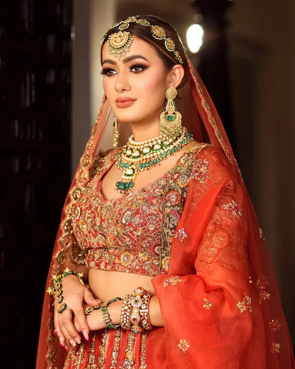 This is the epitome of bridal grace. I focused on creating a flawless, radiant base that glows under any light, paired with defined, captivating eyes and a soft peachy-coral lip. It's a timeless look that ensures you look and feel like the most elegant version of yourself on your big day.