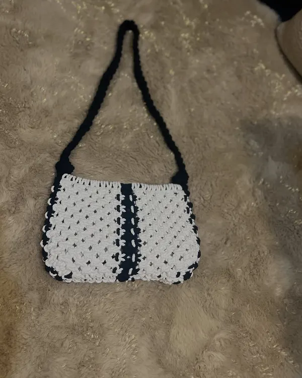 My take on the classic baguette bag, handcrafted with macrame. This black and white design is timeless and chic, perfect for a stylish shoulder bag that holds your essentials.