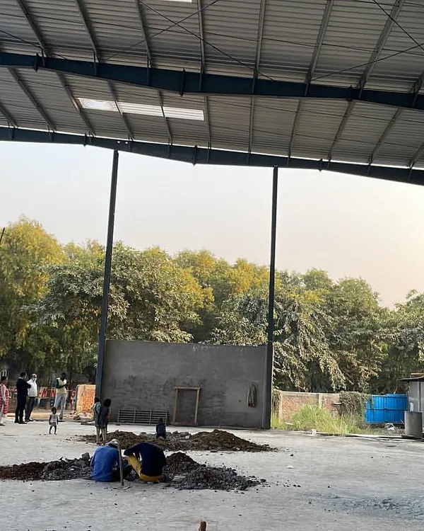 The vast, open interior of a Pre-Engineered Building (PEB) under construction. These steel structures are ideal for industrial applications, offering strength, durability, and a clear span for maximum usable floor space.