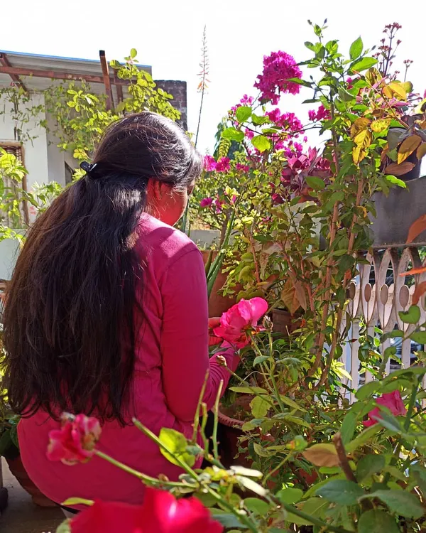 Me in my home garden, surrounded by roses and bougainvillea. Whether it's a large terrace or a small balcony in a new city, I can show you how to start your gardening journey anywhere.