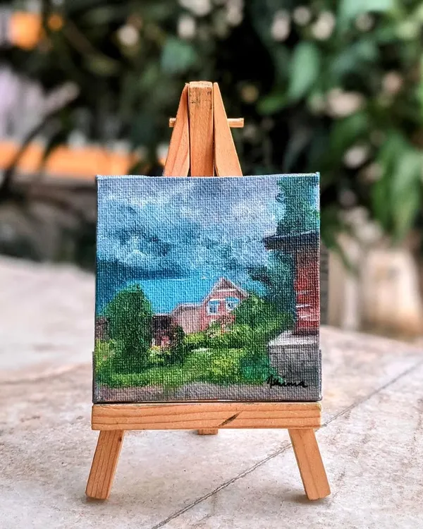 The Manali homestay painting displayed on its easel. This shows how a custom painting of a special place can become a beautiful piece of decor, always reminding you of that happy travel memory.