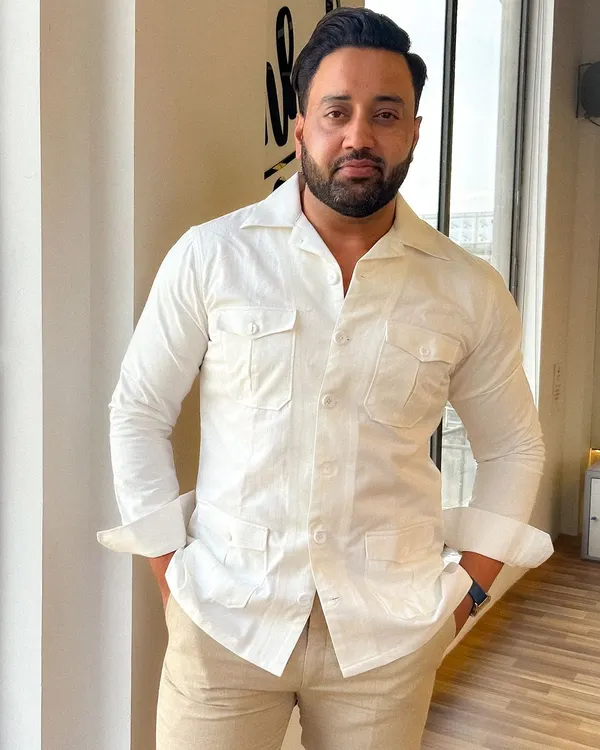 Mr. Vipul Chauhan looking sharp in a custom Levelline safari shirt. Paired with beige linen trousers, it's the epitome of sophisticated summer style.
