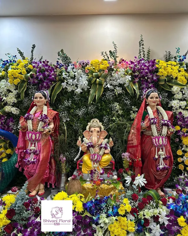 A grand floral arrangement for a complete Gauri Ganpati installation. I designed matching garlands for both Gauri and Ganpati and surrounded them with a vibrant wall of fresh flowers to create a stunning display.