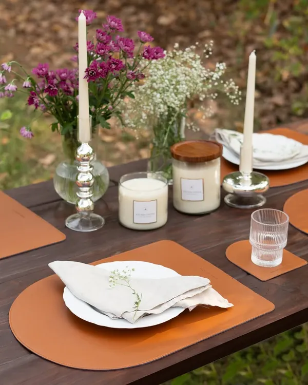 I believe in creating magical moments, and this elegant outdoor table setting shows how my candles can transform any gathering. The layered candlelight from my glass jar candles and classic taper sticks creates a warm, inviting atmosphere perfect for making memories.
