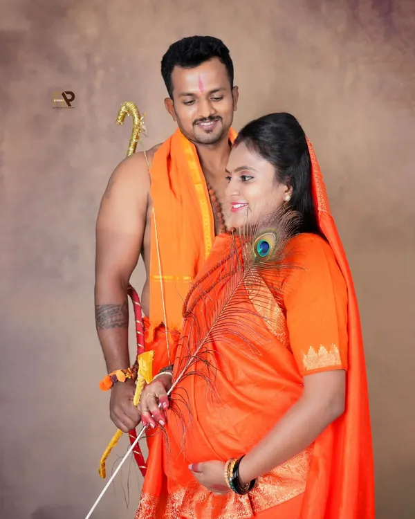 A powerful and artistic maternity portrait from our Seetha-Ram series. The husband holds a bow while the wife holds a peacock feather, creating a symbolic and visually striking image.