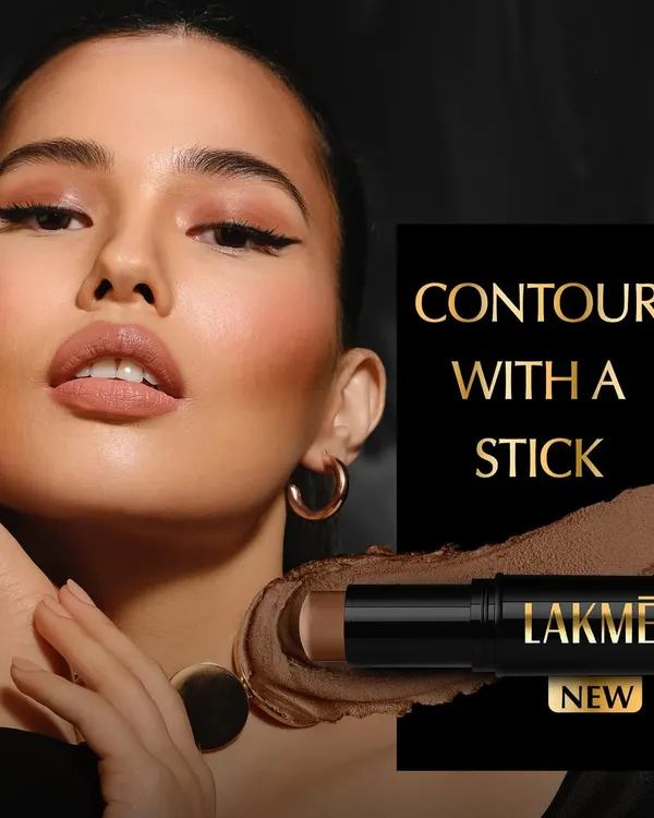 A sophisticated advertisement for a new Lakmé contour stick. The image features a model with a perfectly sculpted look, paired with a product shot and a texture smear to showcase the color and creamy format of the makeup.