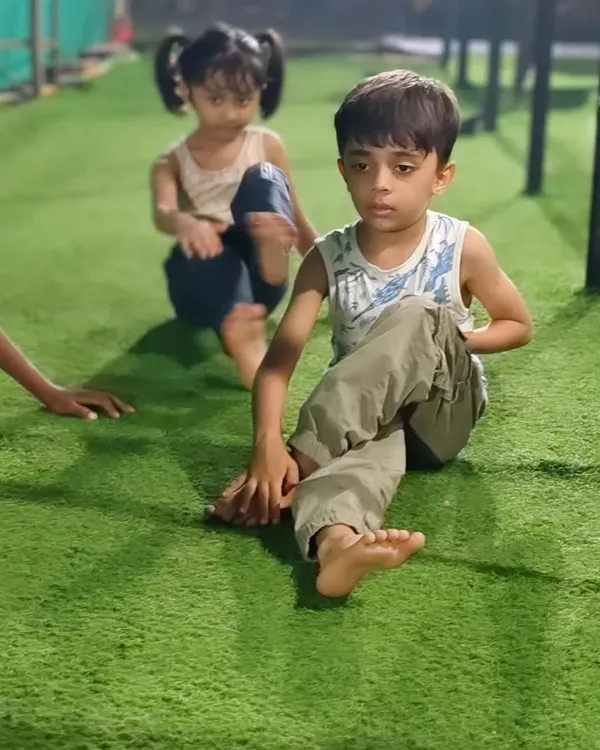 Working on flexibility is just as important as building strength. These young athletes are practicing their stretches on the turf, improving their range of motion.