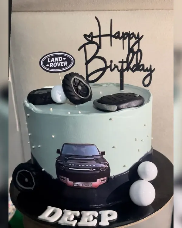For the Land Rover Defender fan, this cake is the perfect tribute. It features the Land Rover logo, fondant tires, a key fob, and an edible image of the iconic vehicle, all on a sleek and modern cake.