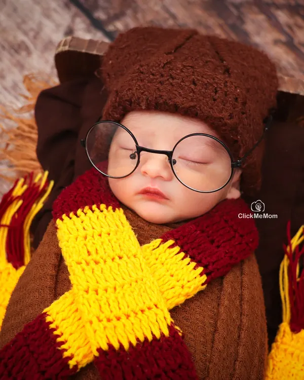 Mischief managed! This close-up of our little Harry Potter shows the adorable details of his themed costume, from the knitted scarf to the iconic round glasses.