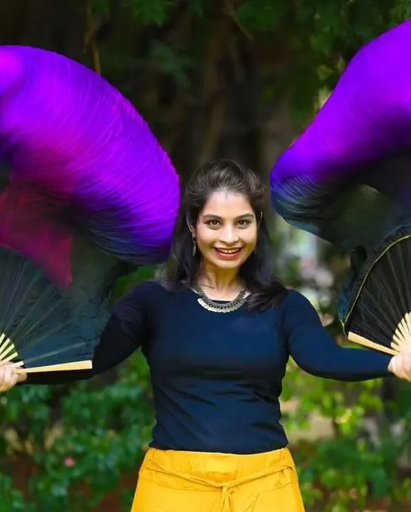 This is from a magazine photoshoot last year. Holding these vibrant silk fans, I feel like I'm holding a pair of wings. They bring such a sense of power and elegance to my dance.