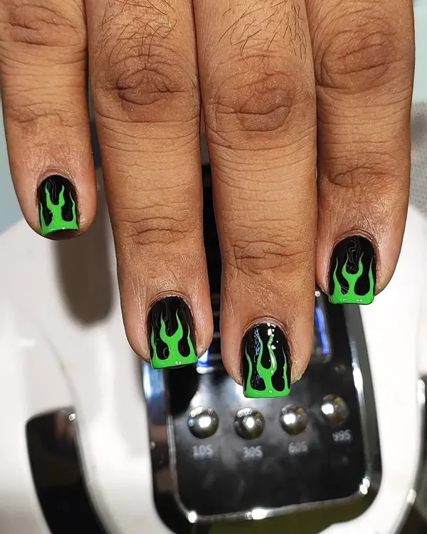 A close-up of the hand-painted neon green flames. The precision of the lines on the black base creates a powerful and fiery look, perfect for anyone wanting to make a statement.