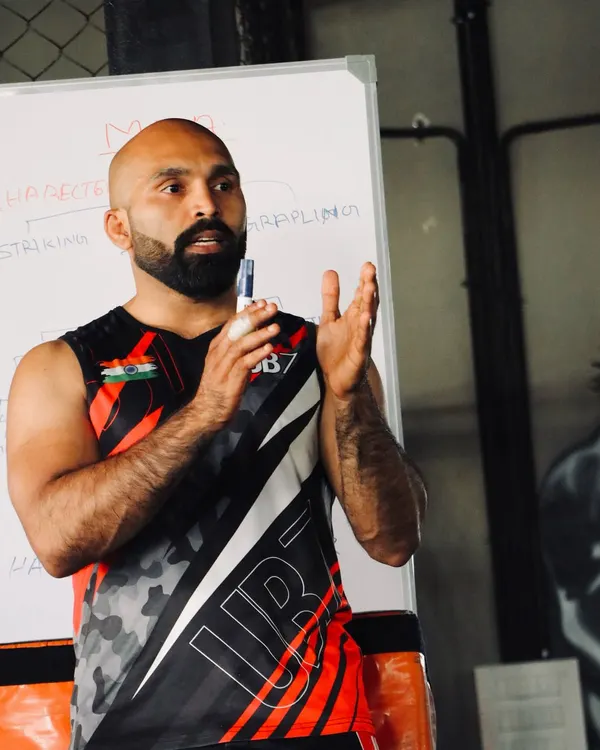 This is where you learn to command a room. I break down the theory of striking, grappling, and mixed martial arts so you can teach it with authority.