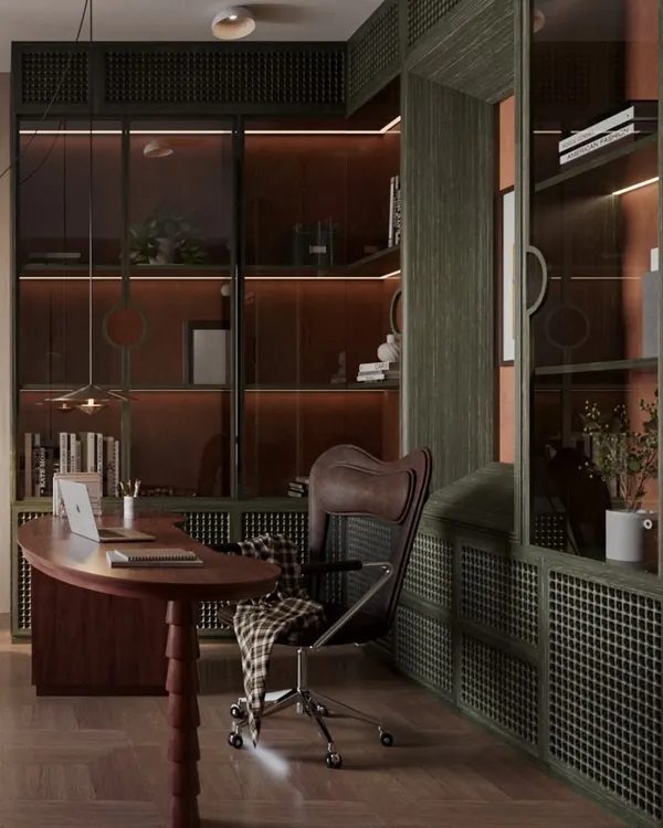 This study is designed as a sophisticated workspace, dominated by deep green custom cabinetry with integrated lighting. The rich, red-toned wood of the curved desk provides a striking contrast, creating a powerful and inviting atmosphere.