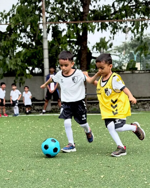 Two of our youngest players compete for the ball in a practice match, learning the basics of tackling and defending in a fun, supportive setting.