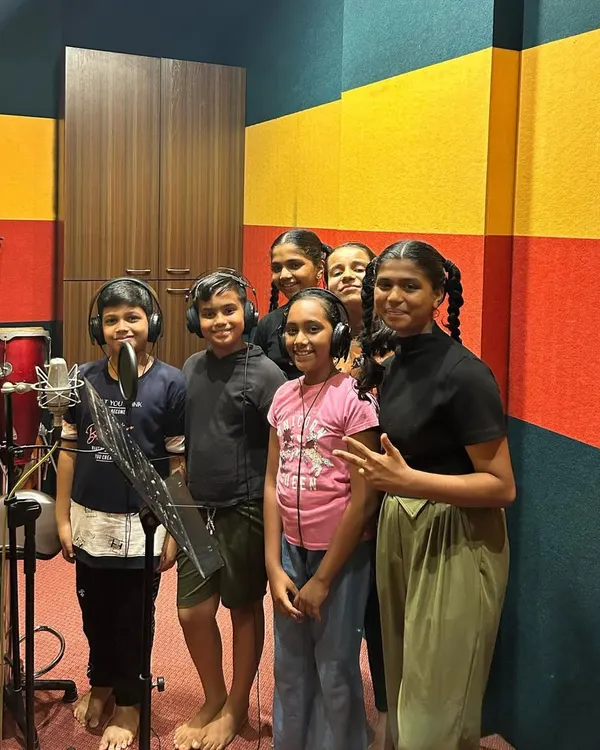 A group of our students inside a professional recording studio, ready to sing into the condenser microphone. This is a fantastic opportunity for them to understand how professional music is made.