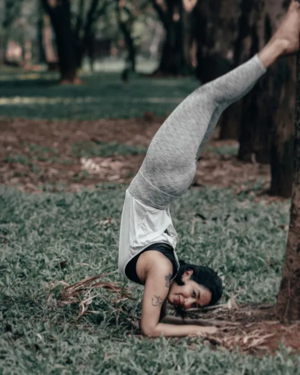 Working on Pincha Mayurasana, the Forearm Stand, using a tree for support. This inversion builds incredible shoulder and back strength without putting pressure on the head, teaching us to get back up every time we fall.