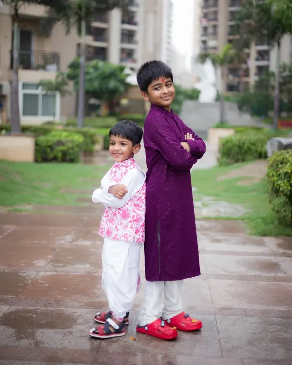 A fun and confident pose from two brothers during an outdoor photoshoot. We love capturing the bond between siblings.