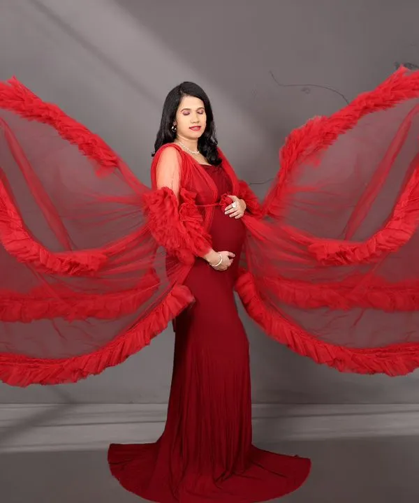 This is the essence of our fairytale maternity sessions. We use flowing fabrics and artistic lighting to create breathtaking, powerful portraits that celebrate the strength and beauty of motherhood. This stunning red gown is part of our extensive client wardrobe, available for your shoot.