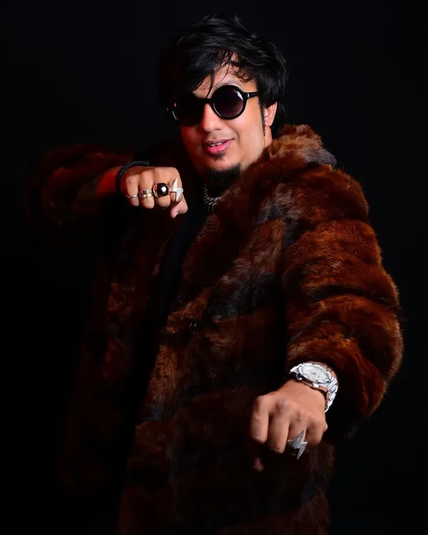 This look, with the fur coat and rings, is part of my personal brand. It reflects the "hustler" mindset of turning wounds into wisdom.