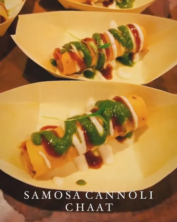 A true fusion creation, my Samosa Cannoli Chaat. A crispy cannoli shell is filled with a savoury samosa mixture and drizzled with yogurt, mint, and tamarind chutneys.