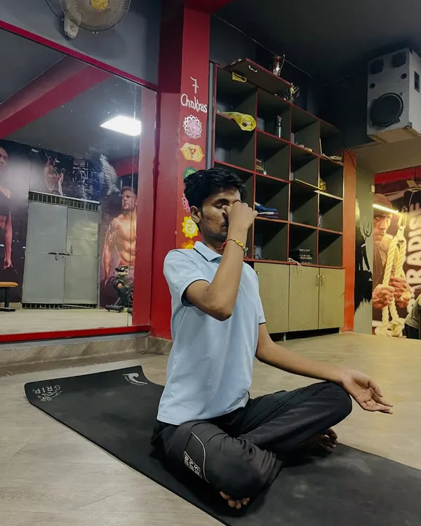 A student practicing Nadi Shodhana (alternate nostril breathing), a powerful pranayama technique I teach to calm the mind and reduce stress.