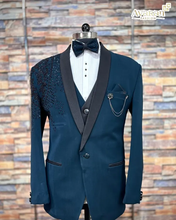 The front view of our popular five-piece teal blue suit for rent. This complete set provides everything you need for a polished reception look, including the jacket, waistcoat, shirt, trousers, and bow tie.