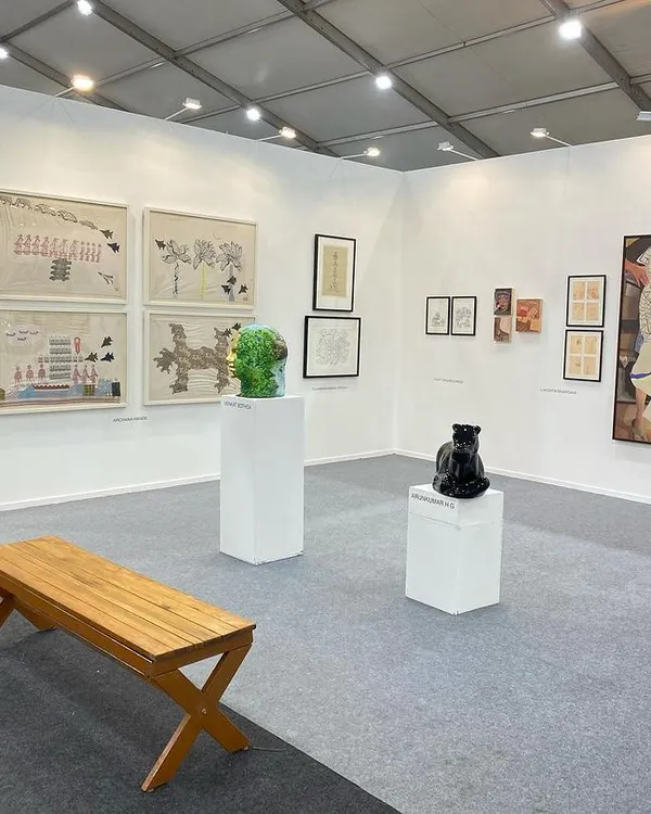 A wide view of our curated booth at Art Mumbai 2024. The display features a mix of sculptures and paintings, demonstrating the variety of mediums and styles we represent, from Archana Hande's textile-inspired works to Venkat Bothsa's sculptures.