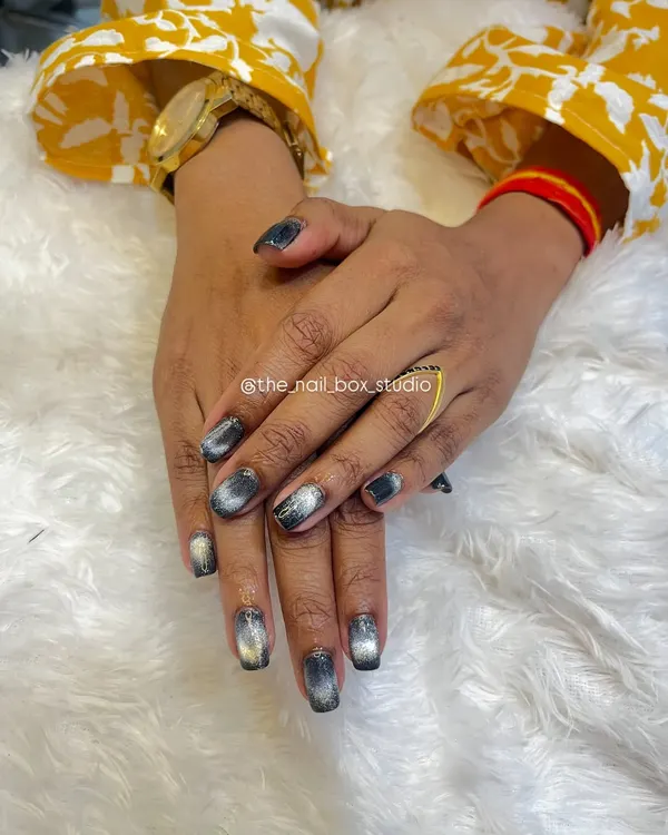 A still photo of the finished Cat Eye nails. The magnetic polish creates a beautiful silver streak that moves across the dark base, resembling a cat's eye.