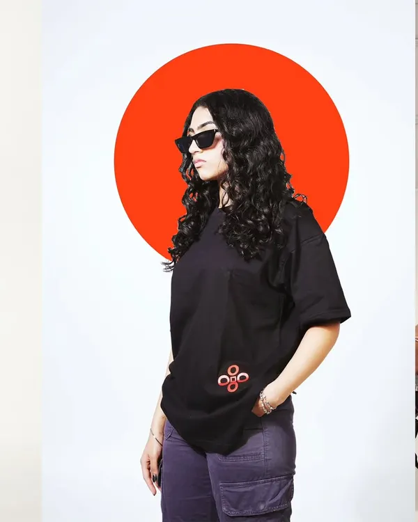 This is my signature style. I combine clean, studio product photography with bold graphic overlays to create visuals that pop for social media and ad campaigns. The focus remains on the apparel, highlighting the black t-shirt and its details, while the design element adds a strong brand personality.