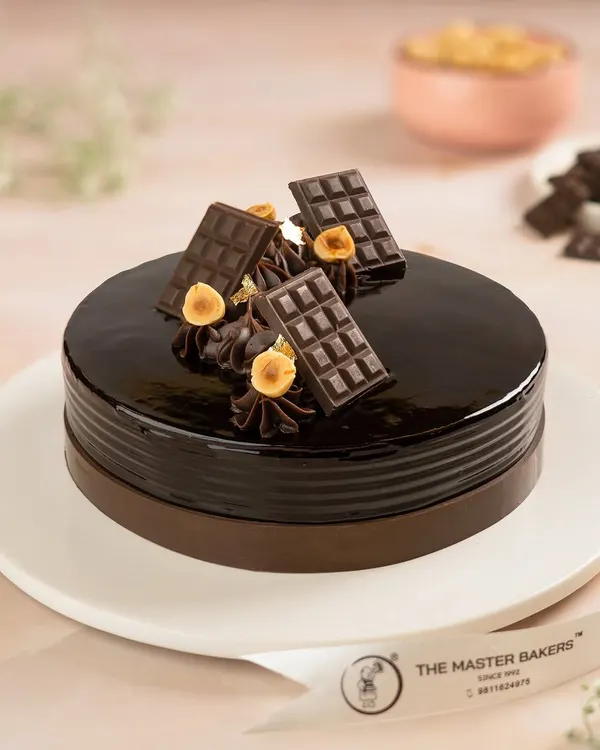 Our Chocolate Truffle Cake is a classic for a reason. With its glossy ganache finish and rich, moist chocolate layers, it's the perfect centerpiece for any celebration that calls for pure chocolate indulgence.