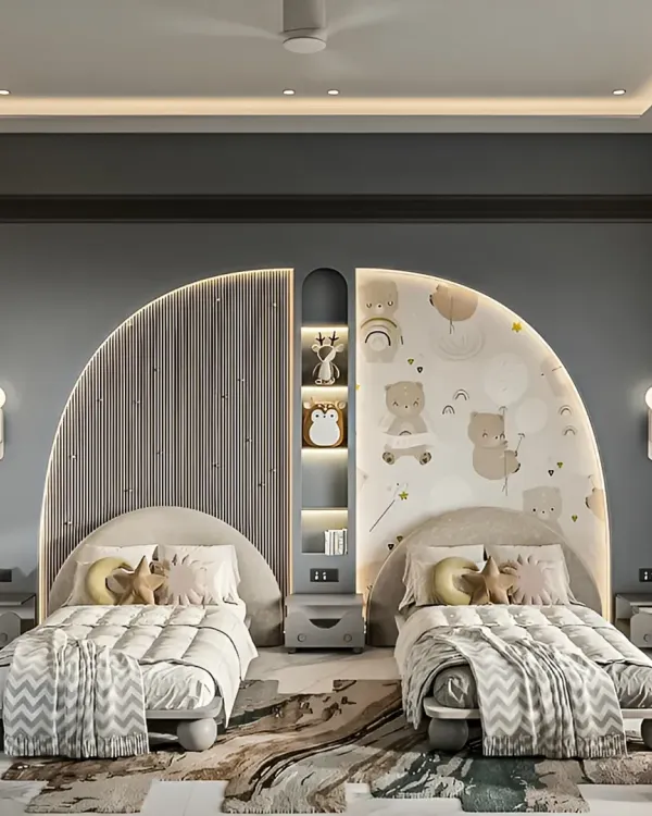 A beautifully designed shared bedroom for siblings, featuring symmetrical curved headboards with distinct fluted and patterned details. Integrated shelving and soft, ambient lighting create a cozy and personalized space for each child.