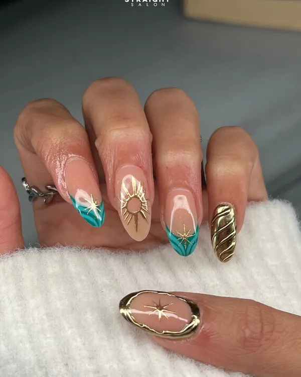 A celestial-inspired set featuring a mix of techniques. Notice the hand-painted sunburst, 3D gold sun emblem, and sculpted gold textures, all combined to create a truly unique and artistic manicure.