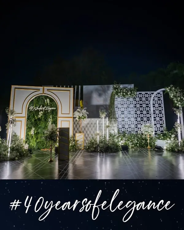 The full view of the '40 Shades of Elegance' stage, designed as a sophisticated photobooth. It features a green wall arch, geometric patterns, and integrated lighting, creating a luxurious backdrop for capturing memories.