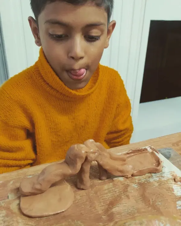 The look of pure concentration and fun! In my "Muddy Puddles" kids workshops, children are free to explore their creativity. These sessions are a wonderful creative outlet after a busy week at school.