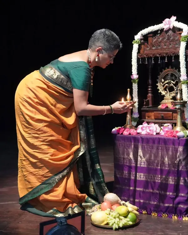 The sacred tradition of lighting the lamp before a performance. Here, I am at the debut recital of my dear student Ambili Krishnan, a moment filled with blessings and hope.
