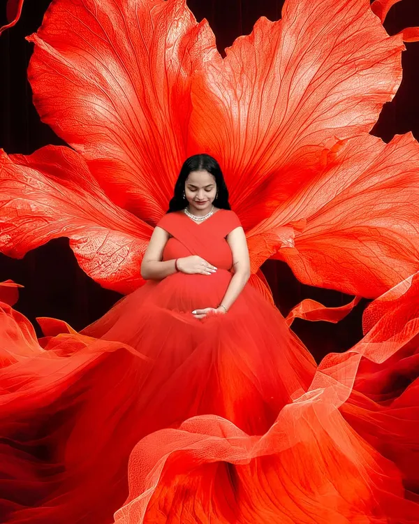 This is one of my favorite setups in the studio. The vibrant red gown and the oversized flower backdrop create a powerful and artistic portrait that truly celebrates the strength of motherhood.