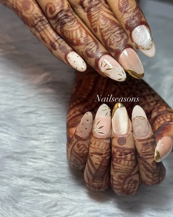 This is the kind of bridal nail art that makes my heart happy. We went for a sophisticated look with delicate gold leaf patterns on a soft, shimmery base to perfectly complement her beautiful mehndi. It’s all about creating that perfect, timeless wedding look.