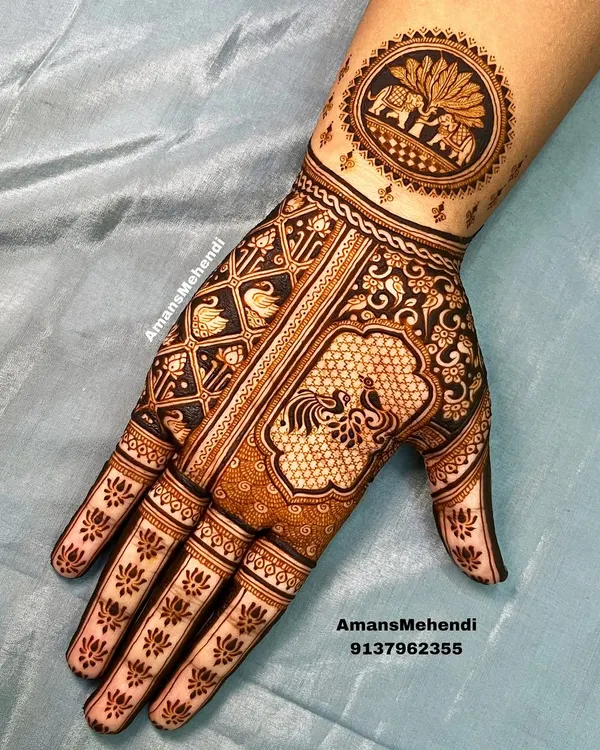 A full palm design showcasing a variety of traditional figures. It includes a circular wrist motif with elephants, a central peacock, and swans in a grid pattern.