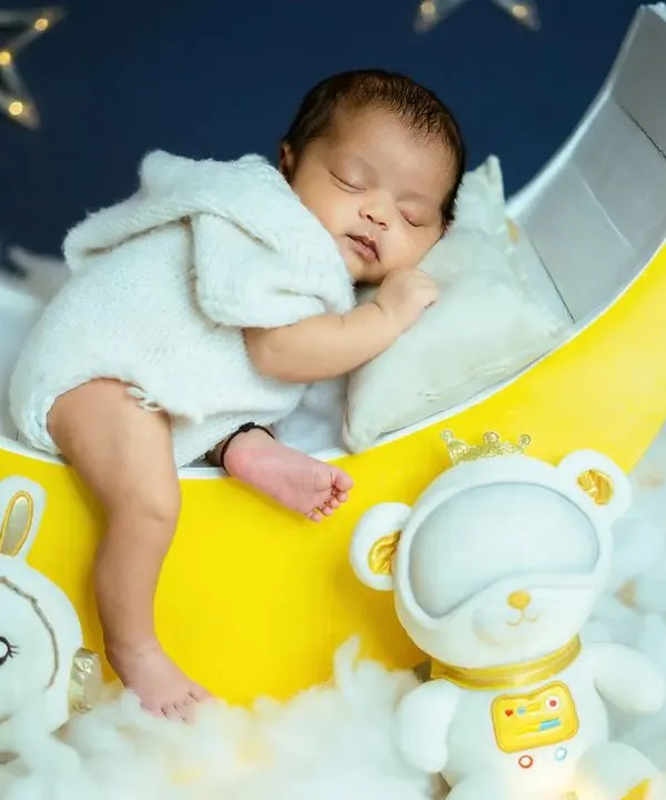 A full view of the 'Blue Moon' newborn setup. The glowing moon prop, soft cotton clouds, and hanging stars create a magical backdrop for your baby's first professional portraits.