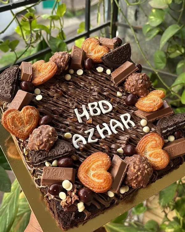 My signature loaded brownie slab is a dream come true for any chocolate lover. I start with a fudgy, eggless brownie base and then load it up with an assortment of treats like KitKat bars, Oreo cookies, Ferrero Rocher, and crispy little heart biscuits. It's a fantastic and fun alternative to a traditional birthday cake.