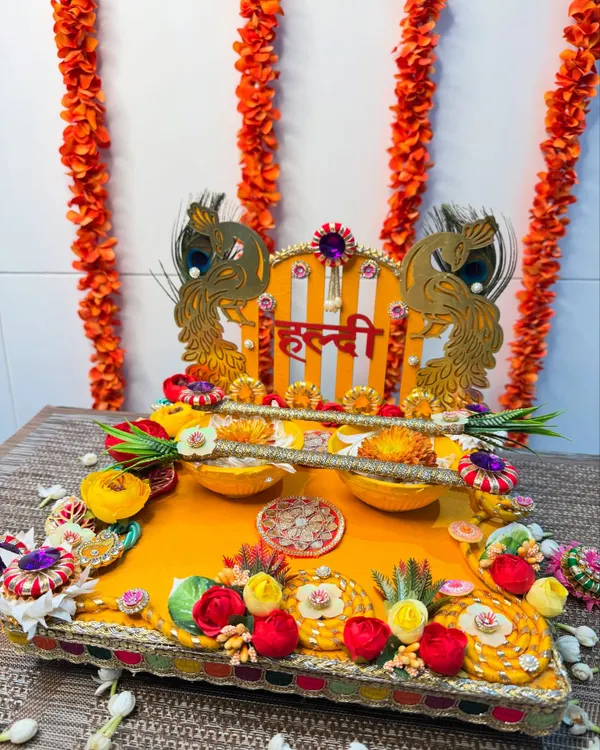 Embrace the sunshine with this gorgeous peacock-themed Haldi platter. The vibrant yellow base, golden peacock cutouts, and colorful floral details are perfect for bringing love, laughter, and a splash of color to your festivities.