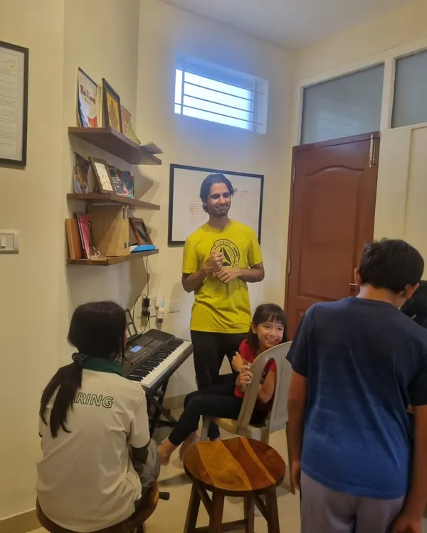 A day in our life at AMP. An instructor engaging with students in a group setting, fostering a fun and interactive learning environment.
